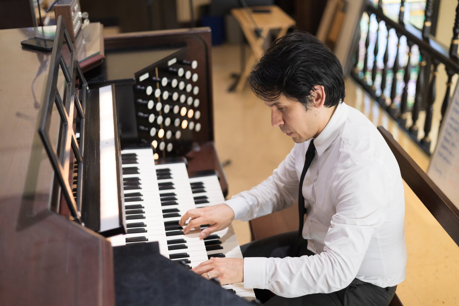 At the organ console, playing